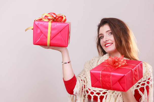 Woman holds red christmas gift boxes - Foto, Imagen