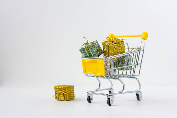 Trolley with gifts on white background - Photo, Image