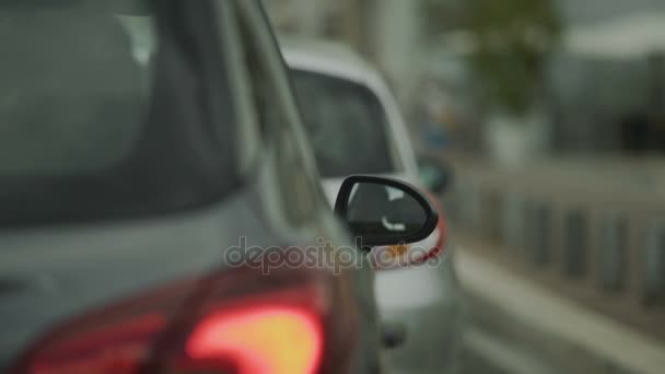 Automobiles standing in traffic jam in the city center, reflection in car mirror - Footage, Video