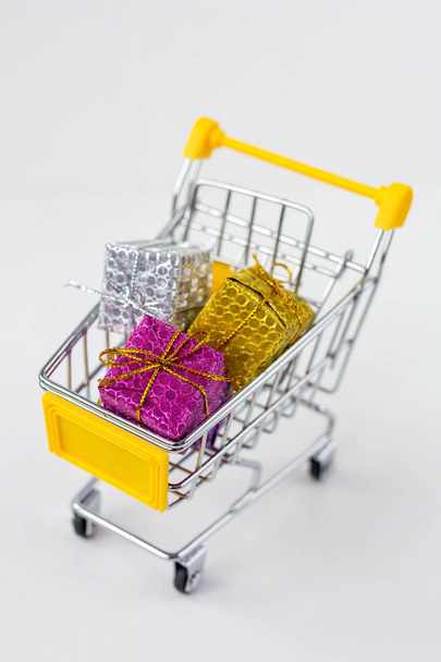 Trolley with gifts on white background - Photo, Image