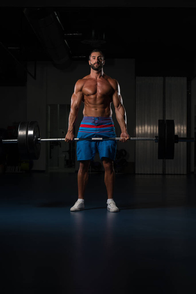Muscular Man Exercising Back With Barbell In Gym - Foto, Imagem