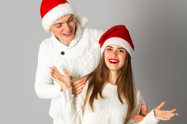 couple in love celebrates christmas in santa hat - Photo, Image