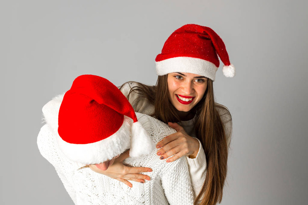 couple in love celebrates christmas in santa hat - Valokuva, kuva