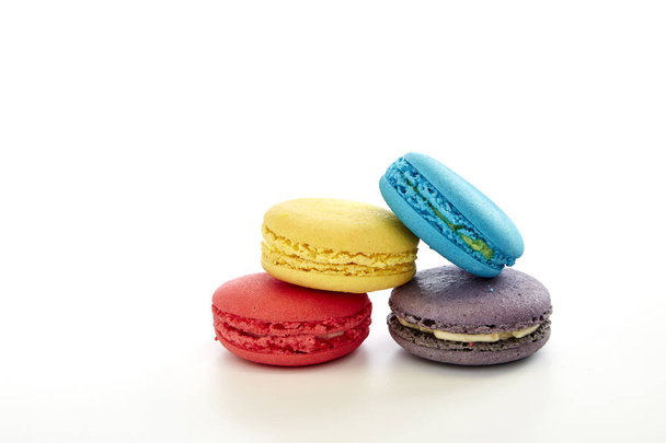 macaron pastry, blue, pink, yellow, purple on white background - Photo, Image