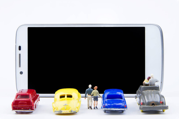 Miniature tiny toys use smartphone as a movie screen.Theme commu - Фото, изображение