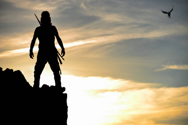silhouette of the brave man on the cliff - Photo, Image