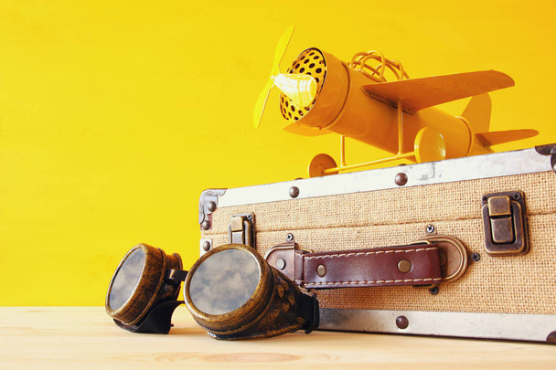 vintage toy plane and old suitcase  - Photo, image