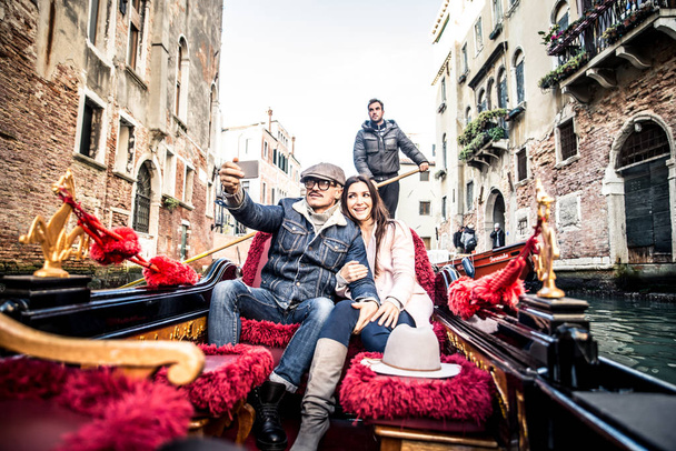 Couple of lovers in venetian gondola - Фото, зображення