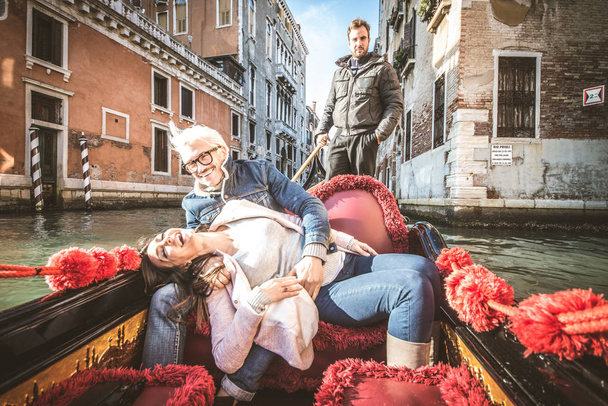 Couple of lovers in venetian gondola - Фото, изображение