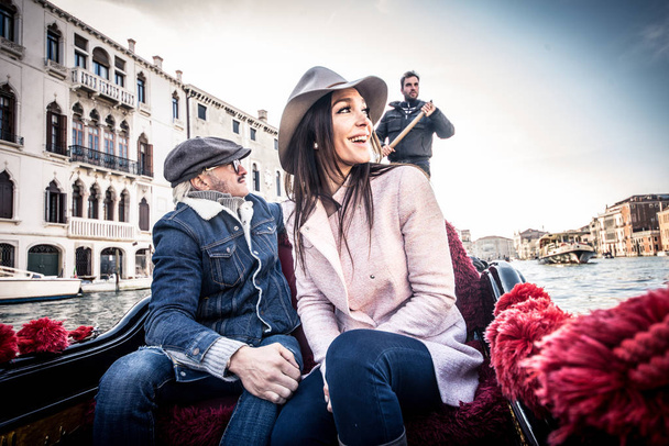 Couple of lovers in venetian gondola - Фото, зображення