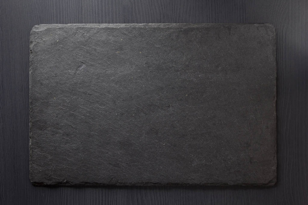 black slate stone on wooden - Фото, изображение