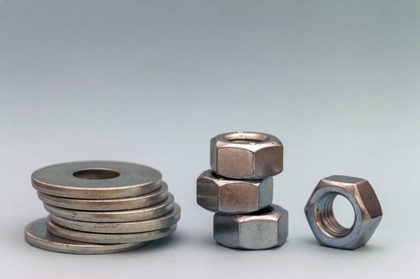 Joiner's accessories. Stacks of metal screw washers and nuts iso - Photo, Image