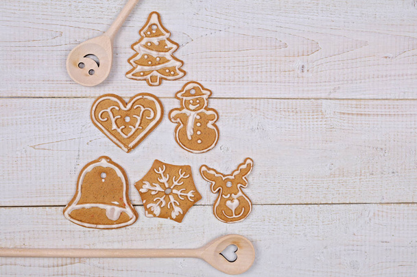 Christmas tree decoration made from gingerbread cookies on white wooden table. New year background, copy space - Photo, Image