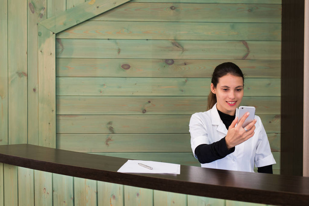 Woman in a spa recpetion uses tablet pc texting to client. Beauty and technology concept. - Fotografie, Obrázek