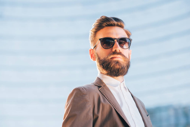 businessman posing wearing sunglasses - Fotografie, Obrázek