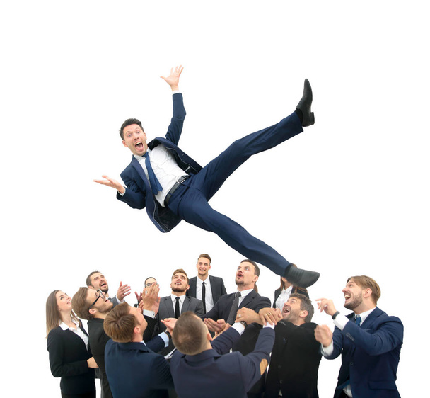 Businessman get thrown into the air by co workers during celebra - 写真・画像