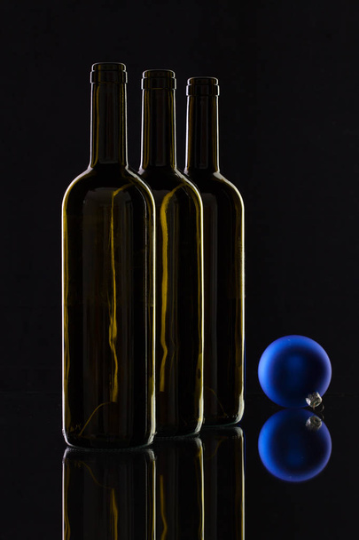 Silhouette of elegant wine bottles and Christmas decoration  - Fotografie, Obrázek