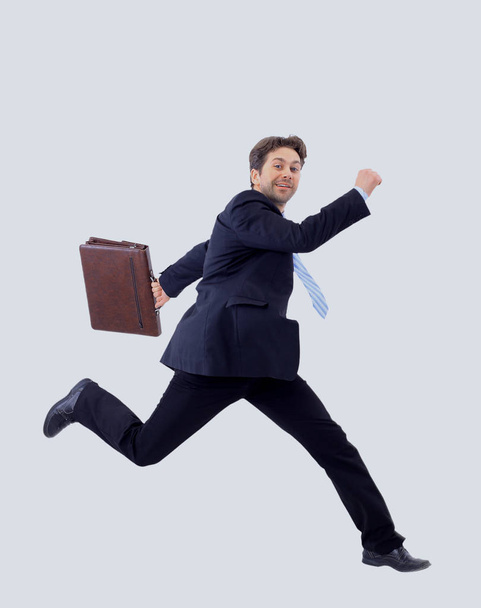 Isolated attractive business man running away from someone - 写真・画像