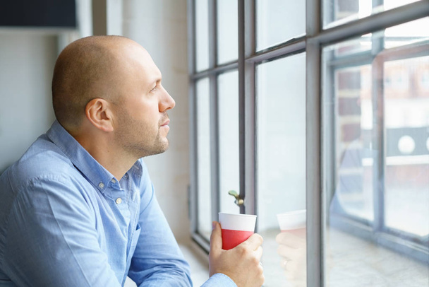 Middle-aged man watching through window - Foto, Imagem