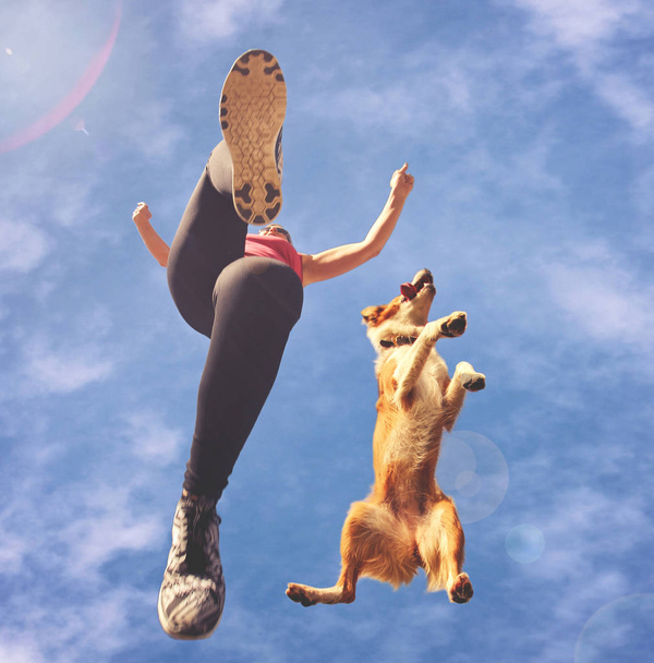 a woman dressed in active wear jumping - Φωτογραφία, εικόνα
