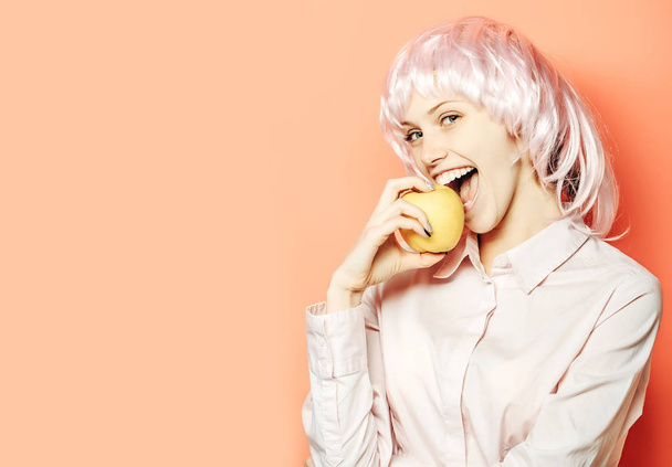 Happy pretty girl eats apple - Photo, Image