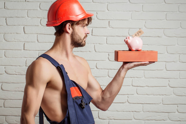seksikäs lihaksikas mies rakentaja kanssa moneybox
 - Valokuva, kuva