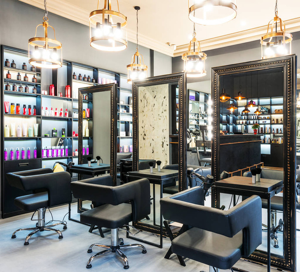 modern designer interior of a beauty salon with mirrors, lamps, armchairs, cosmetics - Photo, Image