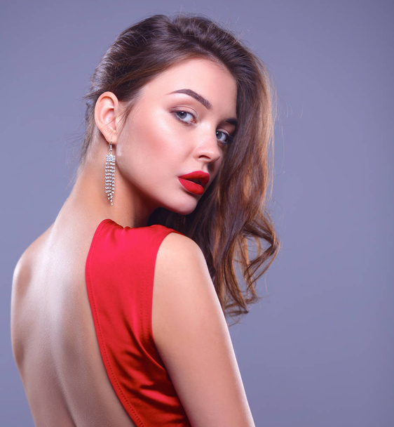 Young woman wearing a red dress standing - Photo, Image