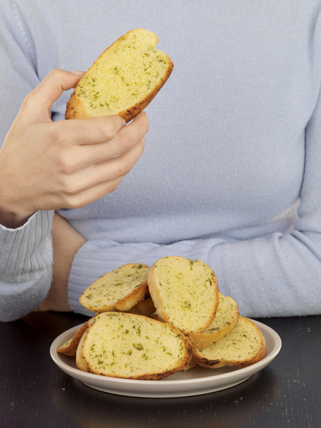Young Woman Eating Garlic Bread - Photo, Image