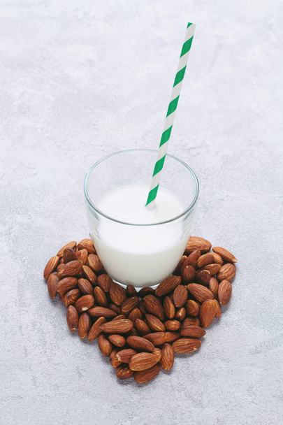 Almond milk in a glass with tube - Zdjęcie, obraz