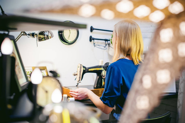 seamstress work on the sewing machine. young blonde woman workin - Fotografie, Obrázek