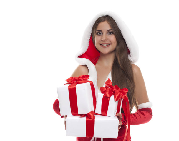 Young smiling woman in santa wear and hat with many gift boxes - Foto, immagini