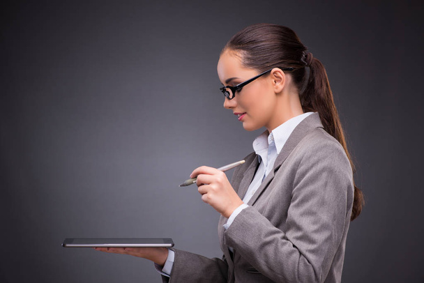 Businesswoman working on tablet computer in business concept - Photo, Image