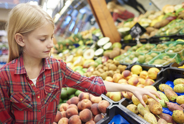 girl in grocery shop - Photo, image