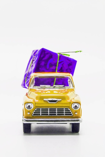 yellow retro car pickup violet gift box isolated - Photo, Image