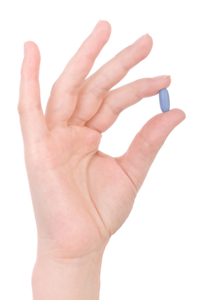 Mano tenendo una pillola blu isolata su bianco
 - Foto, immagini