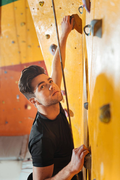 Handsome man training in climbing gym. - Photo, Image