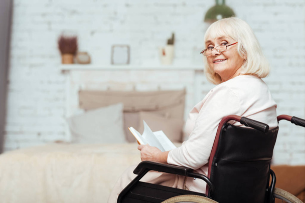Positive elderly disabled woman resting at home - Φωτογραφία, εικόνα