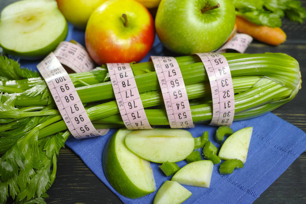 Green vegetables and fruits -  celery shoots and  apples, healthy fitness diet concept - Photo, Image