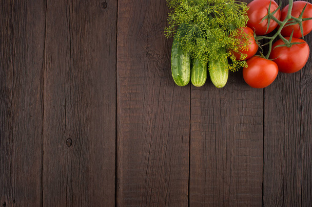 Tomatoes, cucumbers, dill on the old wooden background. - Foto, Bild