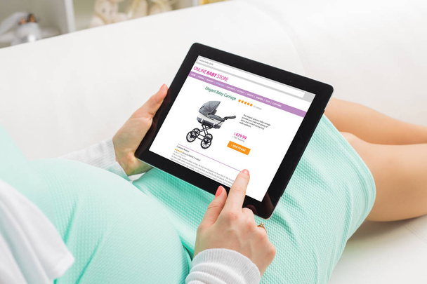 Pregnant woman shopping online on baby store - Photo, Image