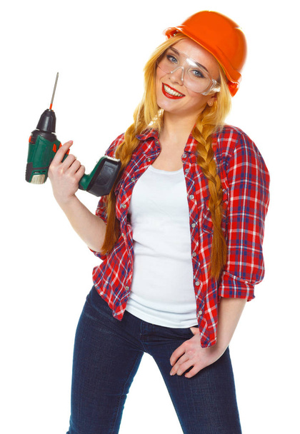 Trabajadora de la construcción en casco con perforadora
 - Foto, Imagen