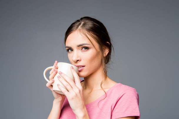 Woman holding white cup  - Photo, Image