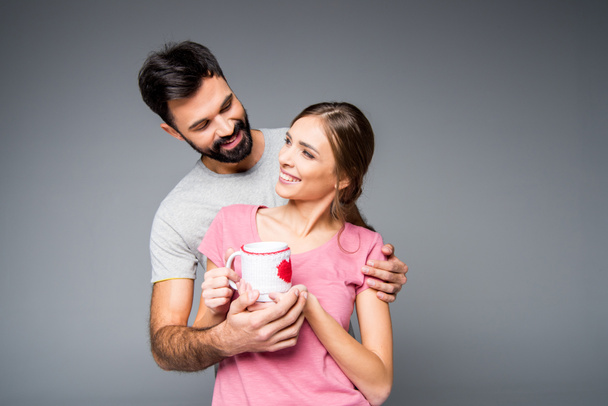 Happy couple holding cup - 写真・画像