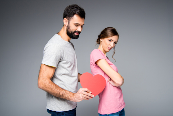 Young couple with red heart - Foto, imagen