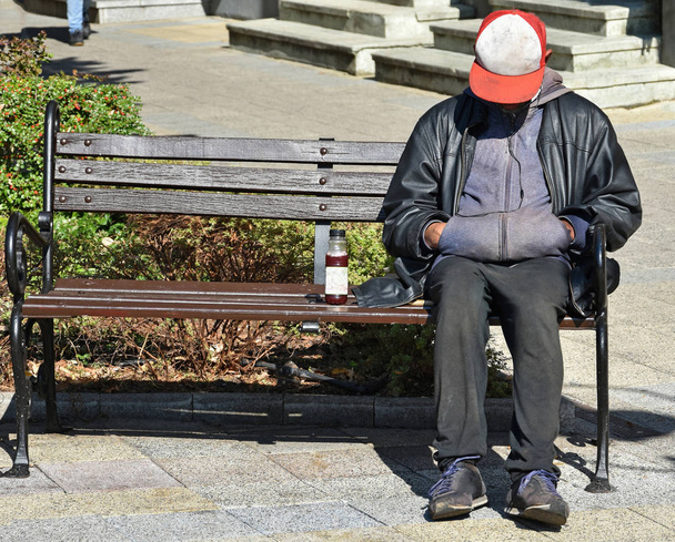 Homeless man sleeps on a bench - Photo, Image