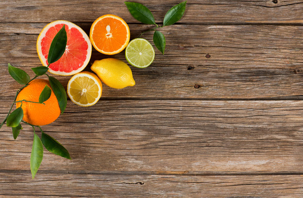Mixed citruses, orange, lemon, lime, grapefruit, above view. - Fotografie, Obrázek