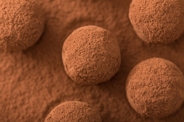 Close up of group of appetizing black chocolate truffles covered - Zdjęcie, obraz