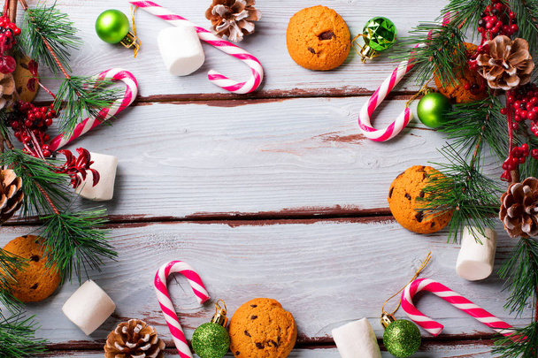 food background with chocolate chip, cookies, marshmallows and candy canes - Foto, Imagen