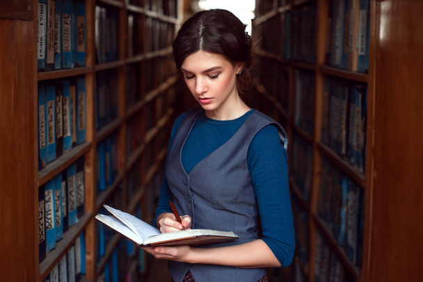 Young woman in university library - Photo, Image
